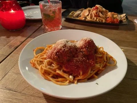 Spaghetti and Meatballs Plate on Rustic Restaurant Table Stock Photos