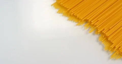 Spaghetti appear on a white background. Close up macro view, shot on RED 6K Stock Footage 107921484