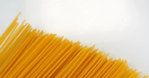 Spaghetti appear on a white background. Close up macro view, shot on RED 6K Stock Footage 107924874