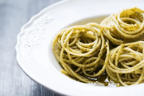 Spaghetti in basil pesto sauce Stock Photos