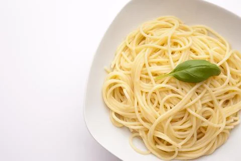 SPAGHETTI WITH BASIL on plate on white background Stock Photos