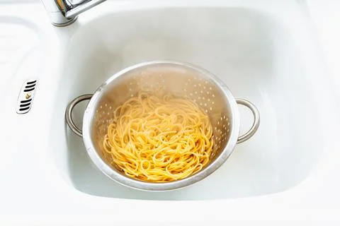 Spaghetti boiled in colander Stock Photos