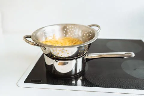 Spaghetti boiled in colander Stock Photos
