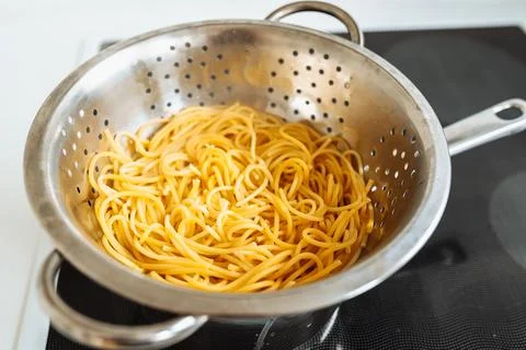 Spaghetti boiled in colander Stock Photos