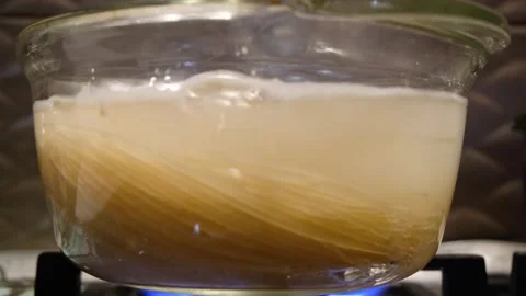 Spaghetti in boiling water. Spaghetti in a transparent pan with boiling water. S Stock Footage 283412071