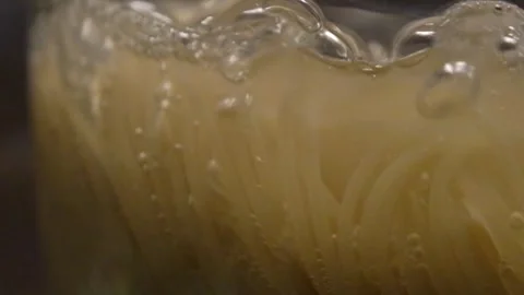 Spaghetti in boiling water. Spaghetti in a transparent pan with boiling water. S Stock Footage 283412124