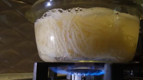 Spaghetti in boiling water. Spaghetti in a transparent pan with boiling water. S Stock Footage 283412160