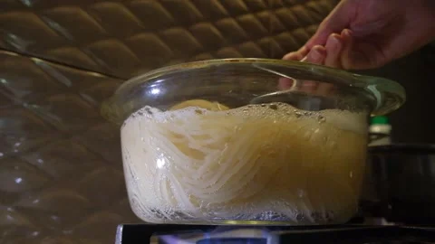 Spaghetti in boiling water. Spaghetti in a transparent pan with boiling water. S Stock Footage 283412246