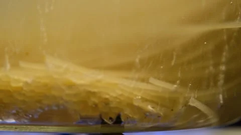 Spaghetti in boiling water. Spaghetti in a transparent pan with boiling water Stock Footage 284174411