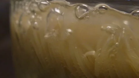 Spaghetti boils in a pan. Spaghetti in a transparent pan close-up. Spaghetti in Stock Footage 284941605