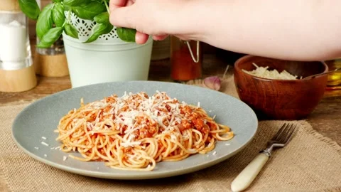 Spaghetti Bolognese. Laying a basil leaf. Decorating the dish. Stock Footage 139686787
