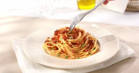 Spaghetti bolognese is picked up with a fork. classic italian pasta with sauce. Stock Footage 244911160