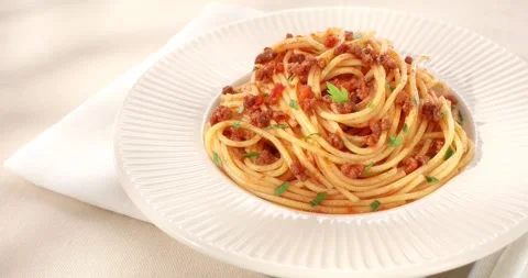 Spaghetti bolognese on a white plate. classic italian pasta with tomato sauce. Stock Footage 242497792