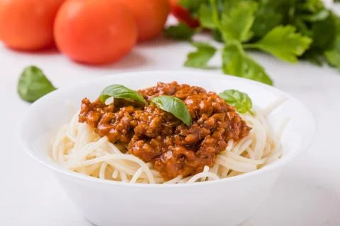 Spaghetti bolognese on white table Stock Photos