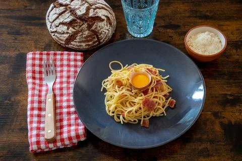 Spaghetti carbonara with an egg on a plate Stock Photos