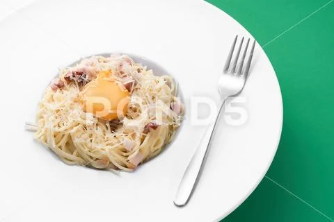 Spaghetti carbonara with egg on white plate. Famous italian national meal. Stock Photos