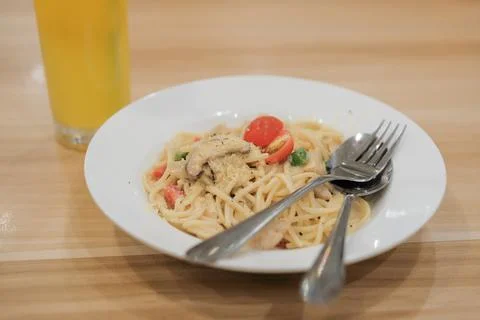Spaghetti Carbonara with ice mango on the table Stock Photos
