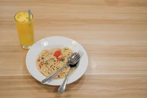 Spaghetti Carbonara with ice mango on the table Stock Photos