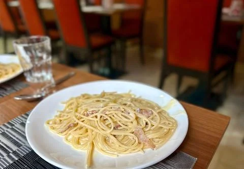 Spaghetti Carbonara in a Restaurant Setting Stock Photos