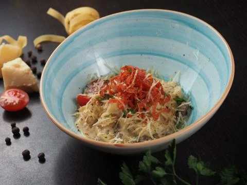 Spaghetti with cheese in a plate on the table Stock Photos
