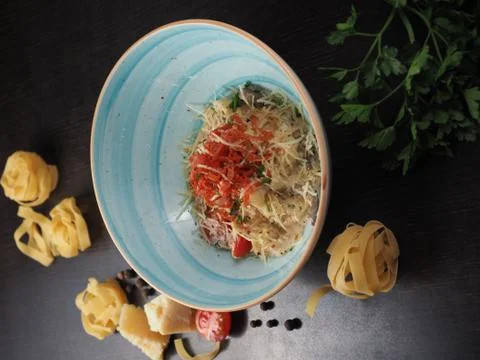 Spaghetti with cheese in a plate on the table Stock Photos