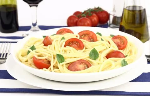 Spaghetti with cherry tomatoes and basil Stock Photos