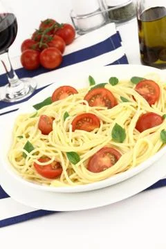 Spaghetti with cherry tomatoes and basil Stock Photos