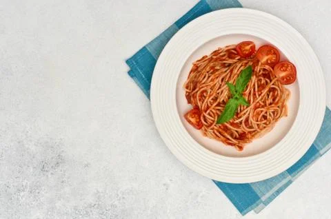 Spaghetti with cherry tomatoes and basil. Italian cuisine. Stock Photos