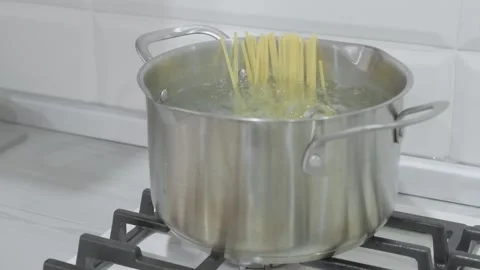 Spaghetti is cooked in boiling water in saucepan Stock-Footage 295037708