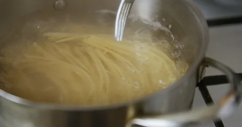 Spaghetti is cooked in pot of boiling water 스톡 동영상 105127503
