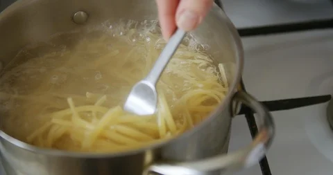 Spaghetti is cooked in pot of boiling water Stock Footage 105127567