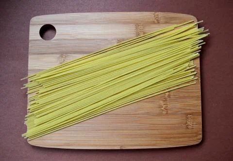 Spaghetti on a cutting Board on a brown background. Foto stock