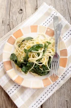Spaghetti with dandelion stem on plate Stock Photos