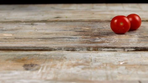 Spaghetti fall on the table with two tomatoes in slow motion Stock Footage 113424460