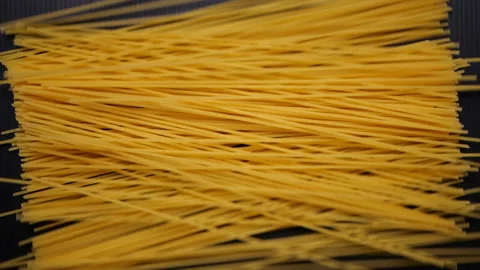 Spaghetti falling on black in slow motion, Top view Stock-Footage 133174501
