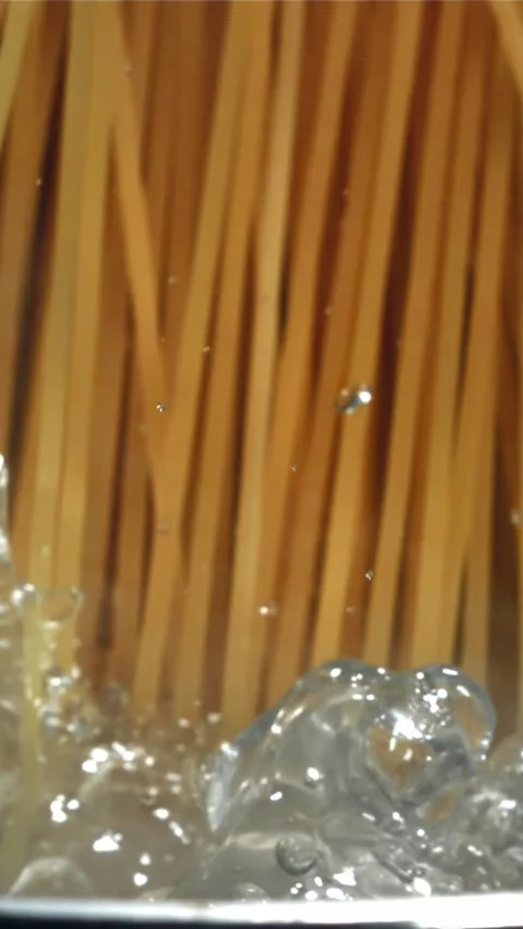 Spaghetti falling into boiling water. Filmed on a high-speed camera at 1000 fps Stock Footage 335359203
