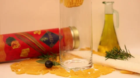 Spaghetti falling into a glass cylinder, dried Italian pasta, slow motion Stock Footage 35991872
