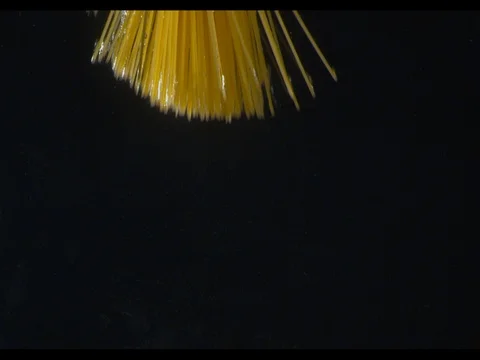 Spaghetti falling in a water in a bunch, unwinding, diving into the water, m/s Stock Footage 74183118
