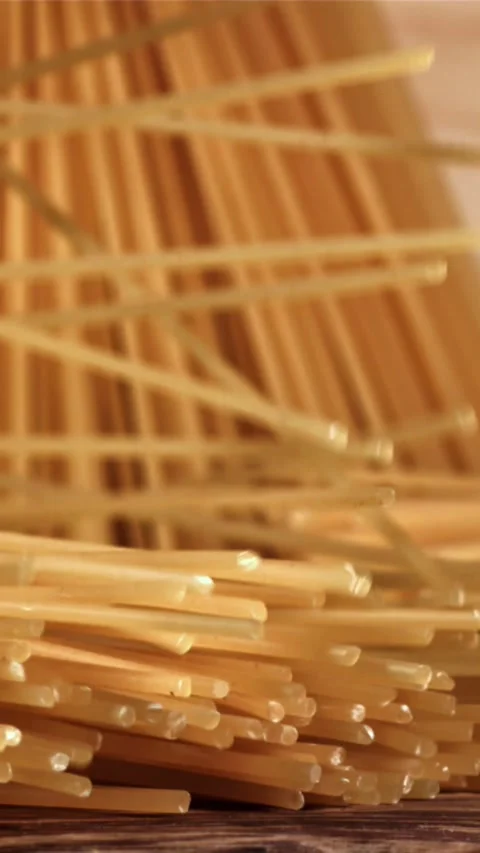 Spaghetti falling on a wooden table. Filmed on a high-speed camera at 1000 fps Stock Footage 335357880