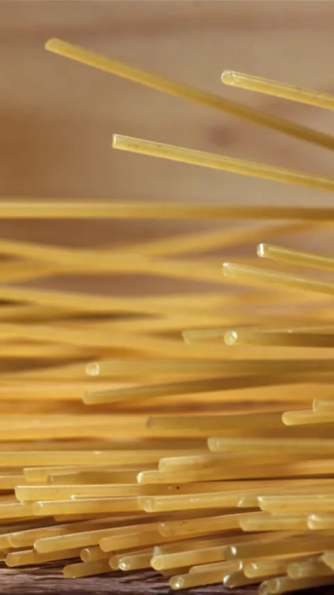 Spaghetti falling on a wooden table. Filmed on a high-speed camera at 1000 fps Stock Footage 335360185