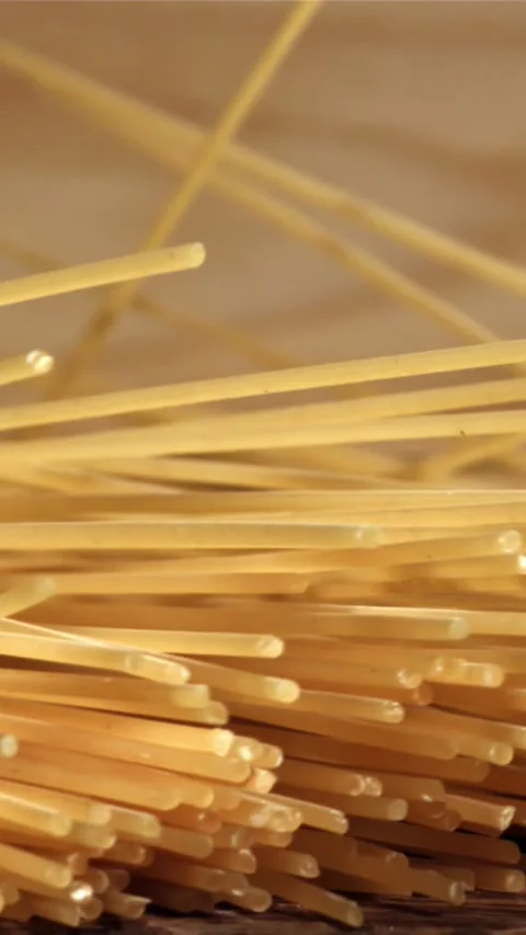 Spaghetti falling on a wooden table. Filmed on a high-speed camera at 1000 fps Stock Footage 335360344