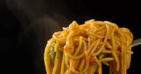 Spaghetti on Fork with Steam Closeup on Black background 4K Stock Footage 104061466