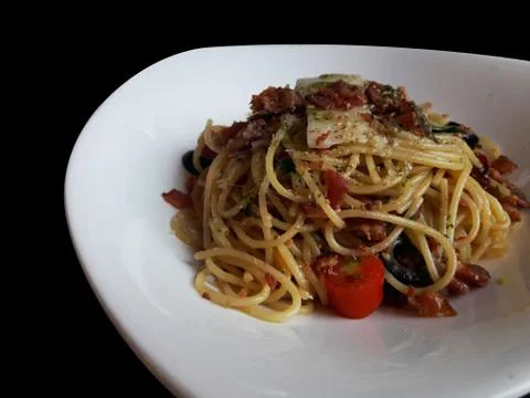 Spaghetti fried with crispy bacon and black olive 스톡 사진