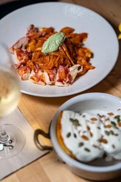 Spaghetti Frutti di Mare on a table set with glass of wine Stock Photos