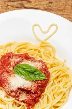 Spaghetti heart on dark wood Stock Photos