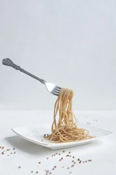 Spaghetti made from buckwheat on a white table Stock Photos
