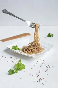 Spaghetti made from buckwheat on a white table Stock Photos