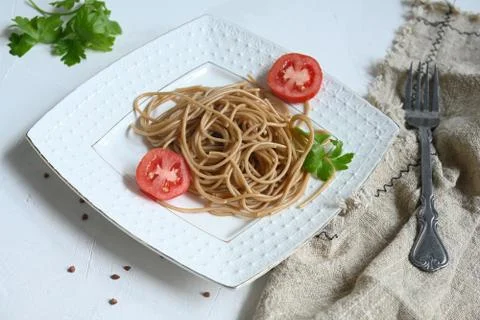 Spaghetti made from buckwheat on a white table Stock Photos