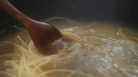 Spaghetti noodle Boiled in boiling water in a pot on the stove Stock Footage 130664613