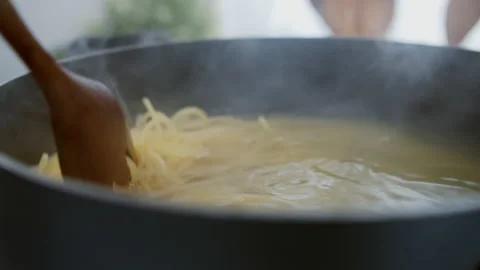 Spaghetti noodle Boiled in boiling water in a pot on the stove Stock Footage 130664810